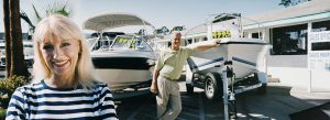 Couple Standing on a Motorboat, Showroom Forecourt